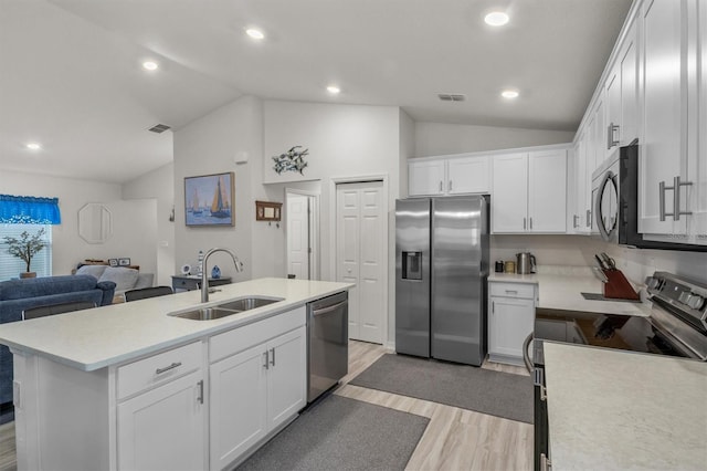 kitchen featuring stainless steel appliances, light countertops, a sink, and white cabinetry