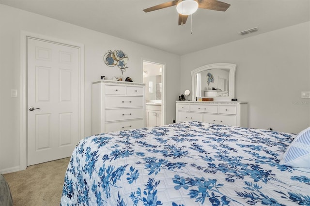 bedroom featuring a ceiling fan, visible vents, connected bathroom, and light carpet