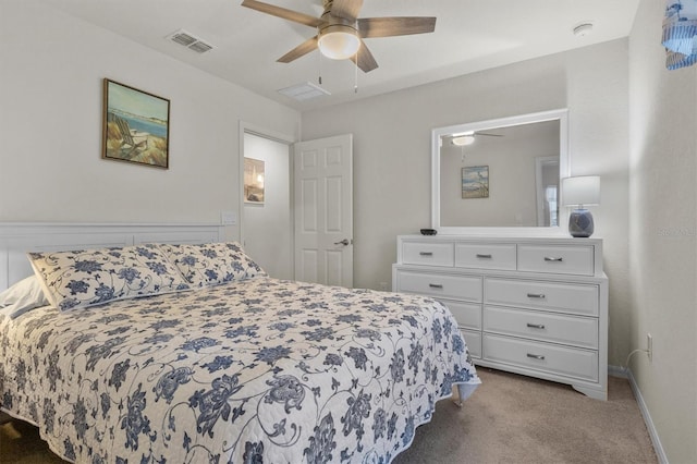 bedroom featuring baseboards, visible vents, a ceiling fan, and light colored carpet