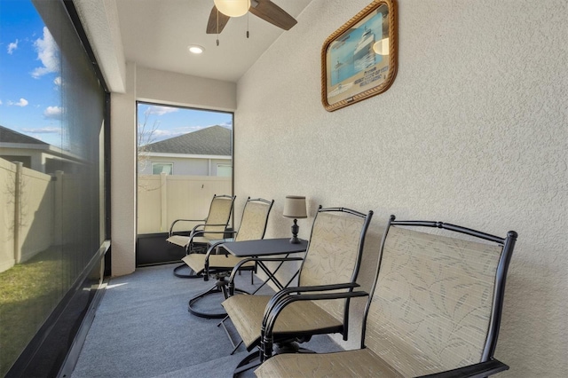 sunroom / solarium featuring a ceiling fan