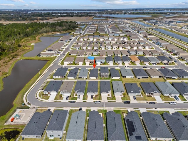 birds eye view of property with a water view and a residential view