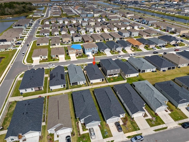 bird's eye view with a residential view and a water view