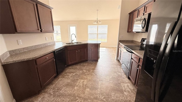 kitchen featuring dark brown cabinets, a peninsula, black appliances, and a sink