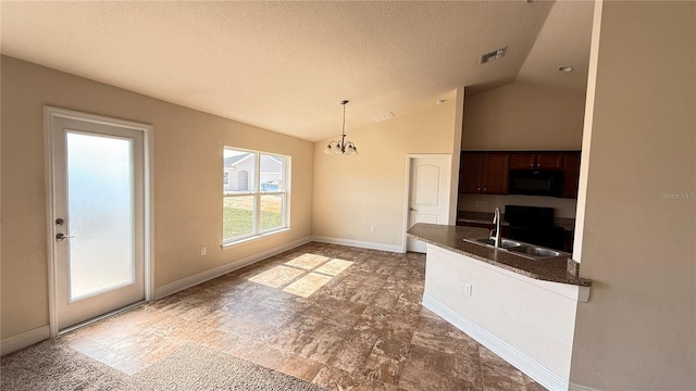 interior space featuring visible vents, a sink, vaulted ceiling, black microwave, and dark countertops