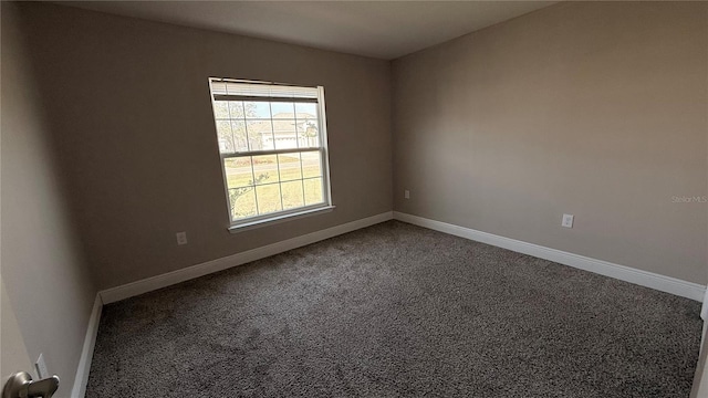 unfurnished room with baseboards