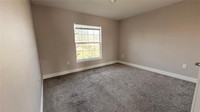 unfurnished room featuring baseboards