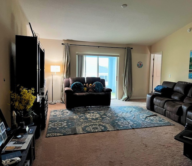 carpeted living room featuring vaulted ceiling