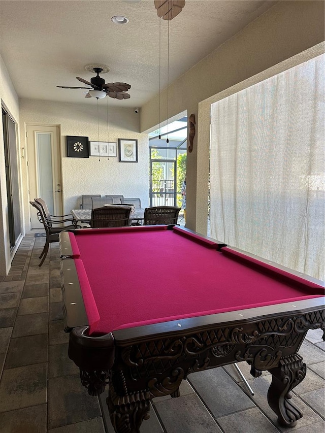 rec room with pool table, ceiling fan, and a textured ceiling