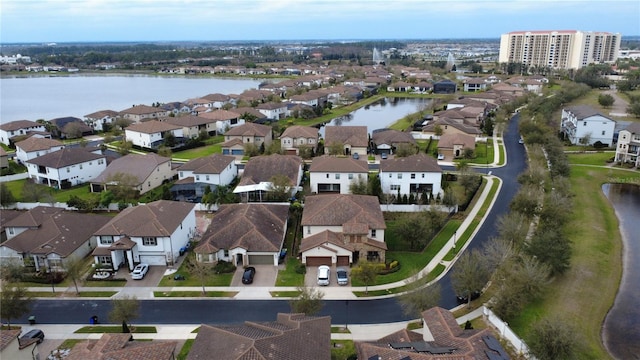 drone / aerial view featuring a water view and a residential view