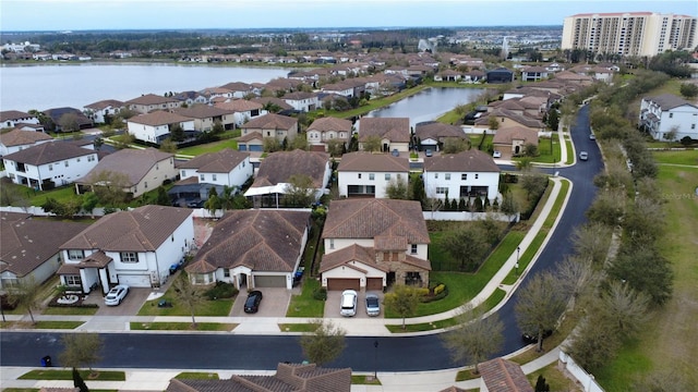 drone / aerial view with a residential view and a water view