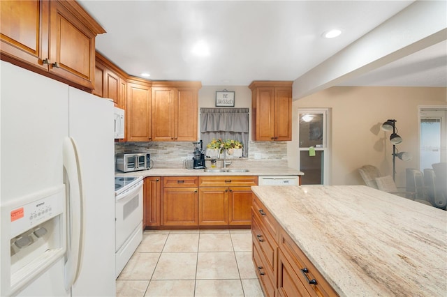 kitchen with white appliances, light stone counters, decorative backsplash, light tile patterned flooring, and sink