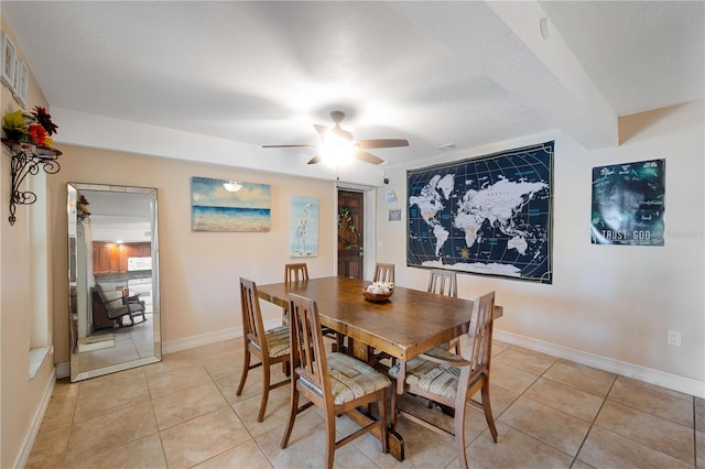 dining space with light tile patterned flooring and ceiling fan