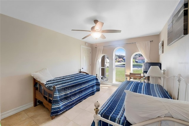 tiled bedroom featuring ceiling fan