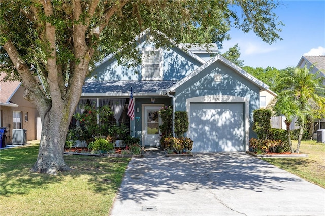 view of front facade featuring an attached garage, central AC, a front lawn, and concrete driveway