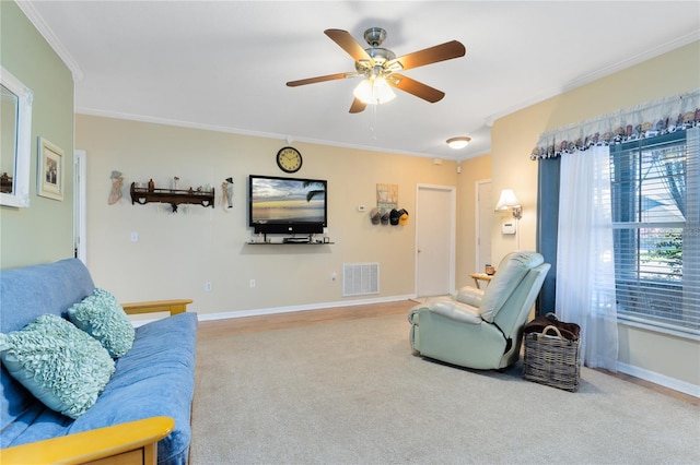 carpeted living area with ornamental molding, visible vents, baseboards, and a ceiling fan