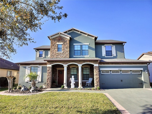 view of front of property with a garage and a front lawn