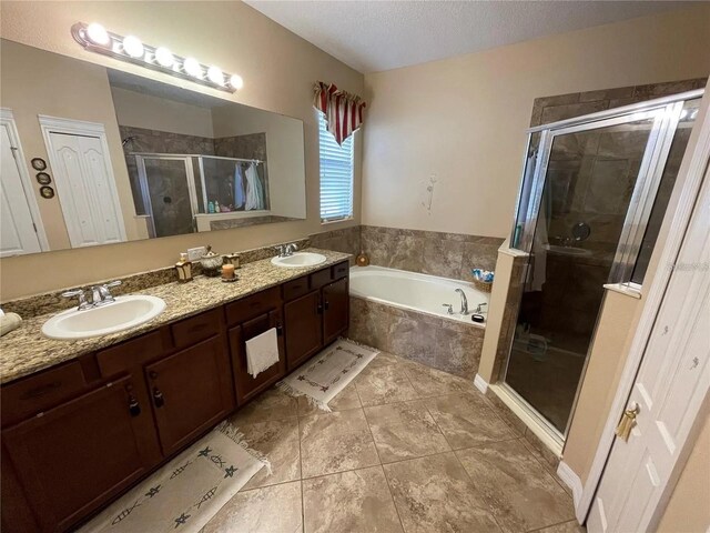 1820 Trophy Bass Way, Kissimmee, FL 34746 - full bathroom with a shower stall, a garden tub, double vanity, a textured ceiling, and a sink