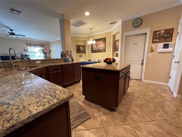 1820 Trophy Bass Way, Kissimmee, FL 34746 - kitchen featuring visible vents, stone countertops, crown molding, and a sink
