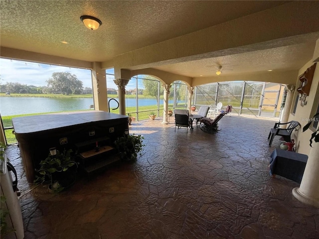 1820 Trophy Bass Way, Kissimmee, FL 34746 - view of patio featuring glass enclosure, a water view, and a hot tub