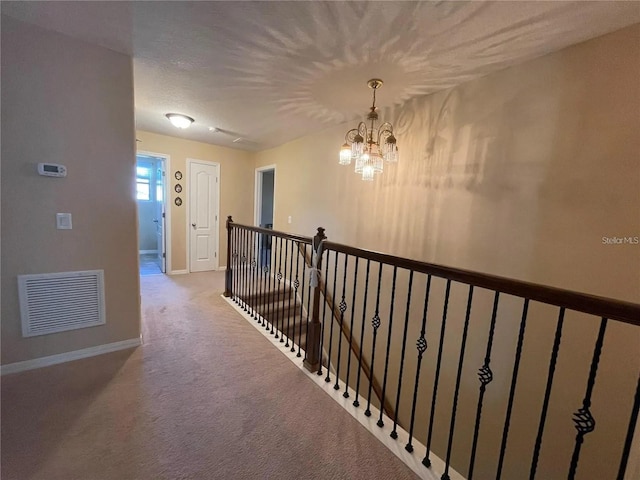 1820 Trophy Bass Way, Kissimmee, FL 34746 - corridor with visible vents, an upstairs landing, carpet flooring, baseboards, and a chandelier
