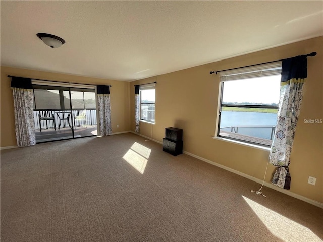 1820 Trophy Bass Way, Kissimmee, FL 34746 - carpeted spare room featuring baseboards, a water view, and a textured ceiling