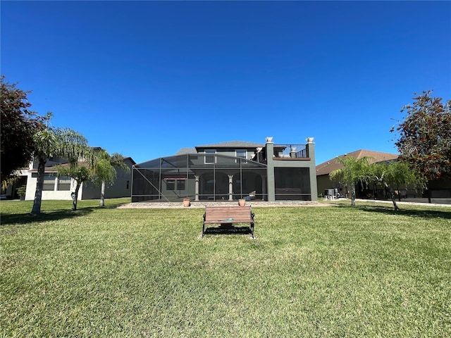 1820 Trophy Bass Way, Kissimmee, FL 34746 - back of house with glass enclosure, a yard, and stucco siding