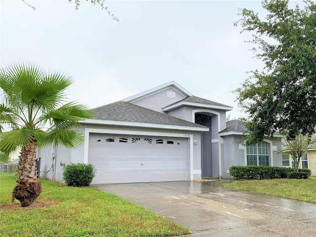 view of front facade featuring a garage, driveway, roof with shingles, stucco siding, and a front lawn