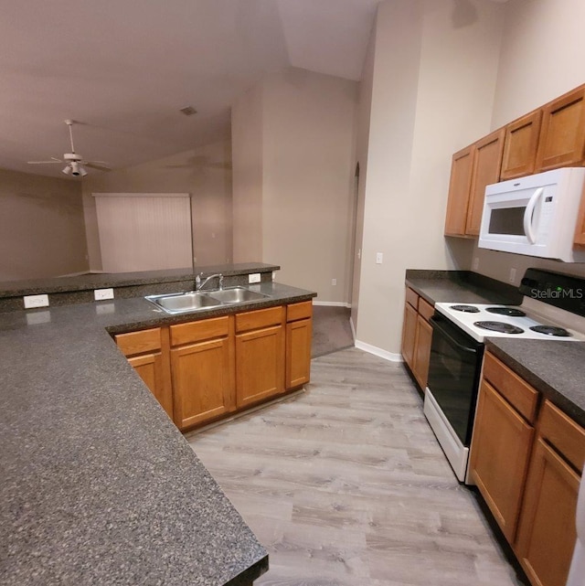 kitchen with lofted ceiling, white microwave, a sink, electric stove, and dark countertops