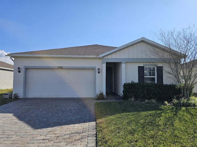 single story home with a garage and a front yard