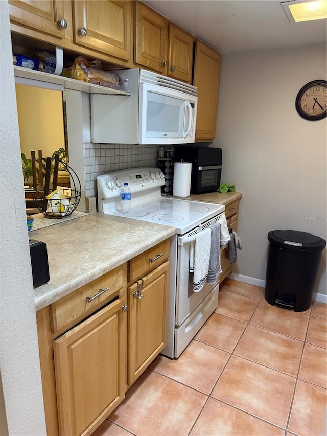 kitchen with white appliances, decorative backsplash, and light tile patterned flooring