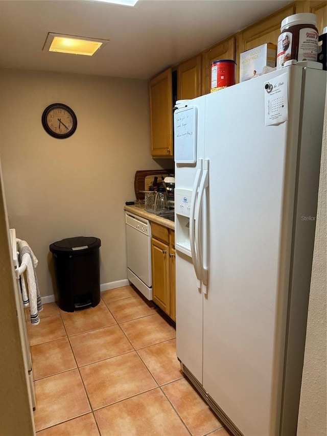 kitchen with light tile patterned floors and white appliances