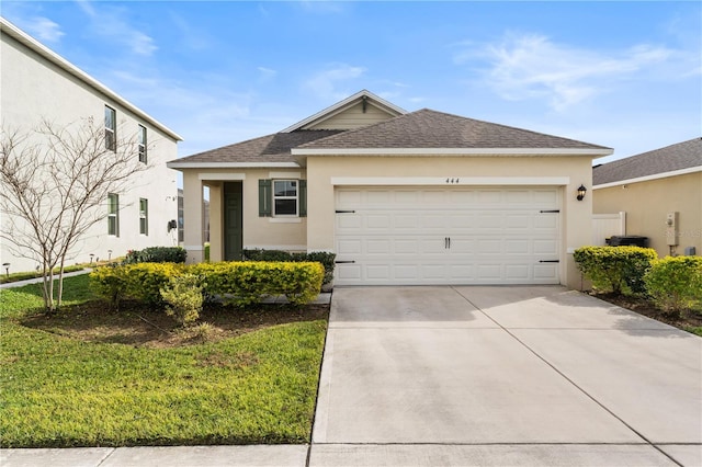 view of front of home with a front lawn and a garage