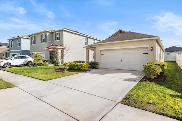 view of front of house featuring a front lawn and a garage