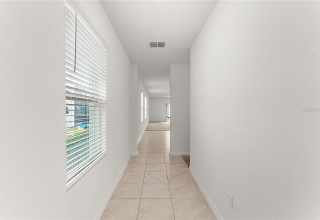 hallway featuring light tile patterned floors