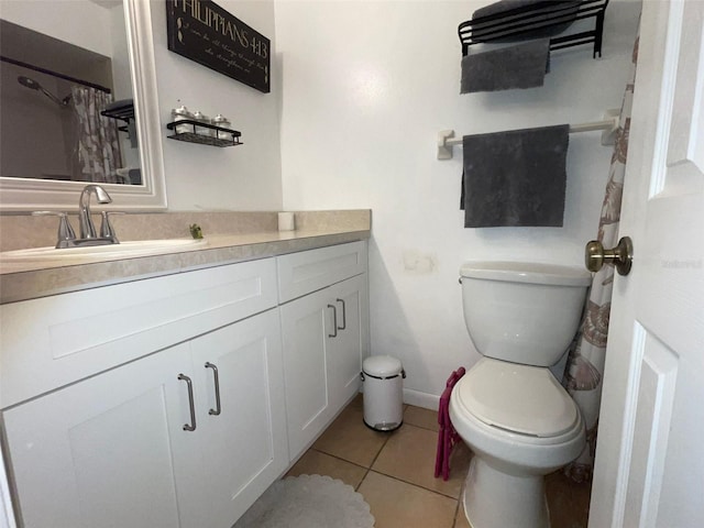 bathroom featuring vanity, tile patterned floors, and toilet