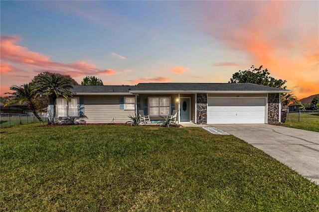 single story home with an attached garage, driveway, fence, and a lawn