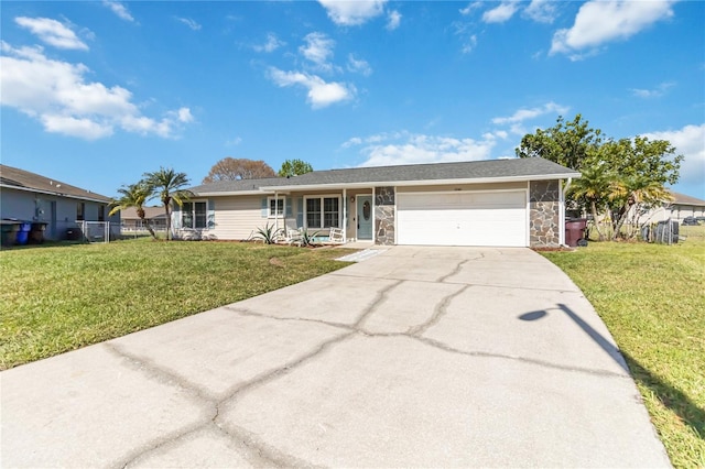 ranch-style home featuring concrete driveway, stone siding, an attached garage, fence, and a front lawn