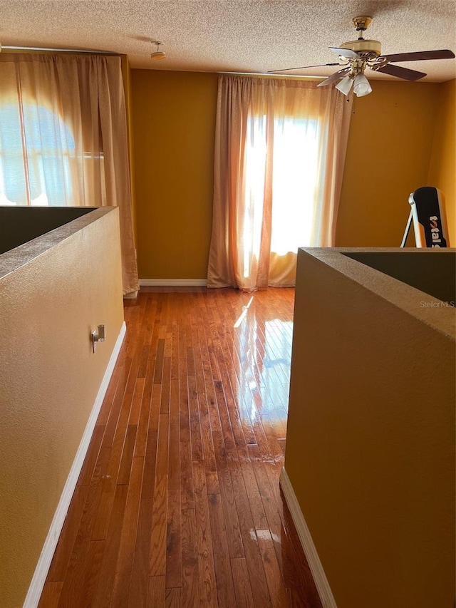 350 Corsica Ct, Kissimmee, FL 34758 - hall with a textured ceiling, wood-type flooring, and baseboards