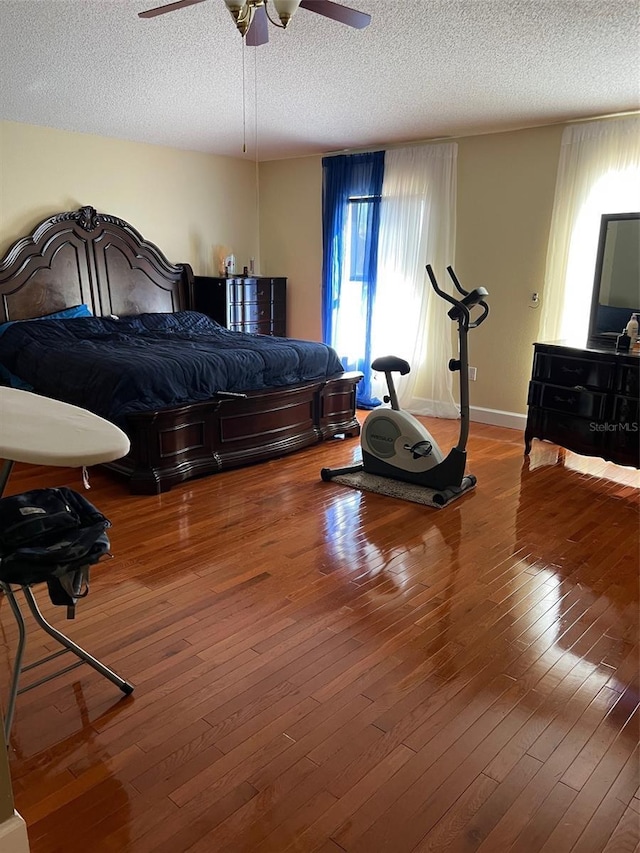 350 Corsica Ct, Kissimmee, FL 34758 - bedroom with hardwood / wood-style floors, ceiling fan, baseboards, and a textured ceiling