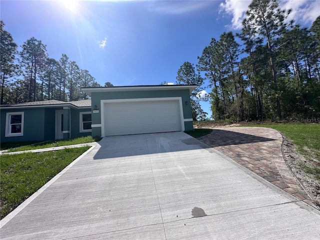 6430 SW 144th Street Rd, Ocala, FL 34473 - view of front of home featuring concrete driveway, stucco siding, and an attached garage