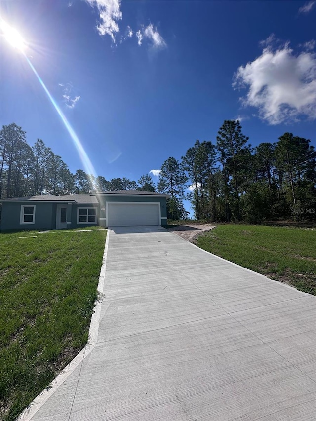 6430 SW 144th Street Rd, Ocala, FL 34473 - view of front of home with concrete driveway, an attached garage, and a front yard