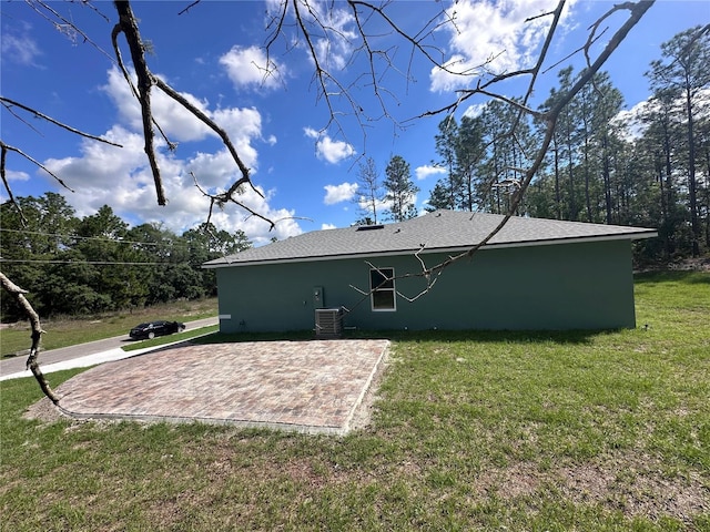 6430 SW 144th Street Rd, Ocala, FL 34473 - back of property with a lawn, central AC, stucco siding, and a patio area