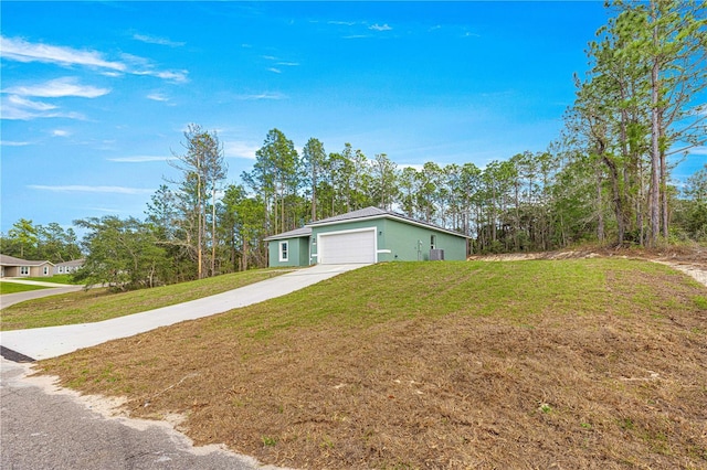 6430 SW 144th Street Rd, Ocala, FL 34473 - view of front of house with a front lawn, concrete driveway, and a garage