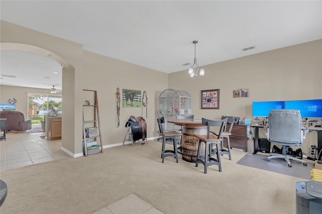 dining area with light carpet and ceiling fan with notable chandelier