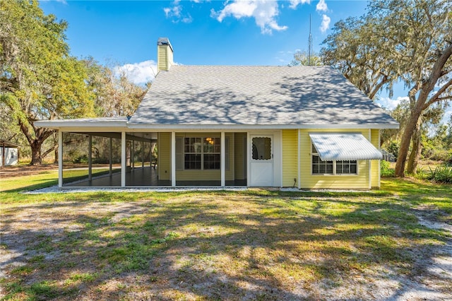 view of front of property featuring a sunroom and a front yard