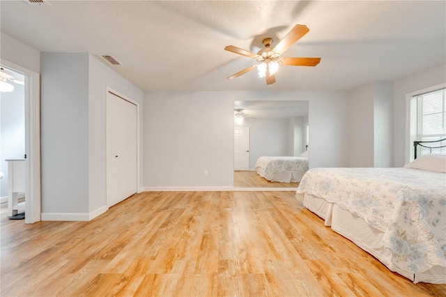 unfurnished bedroom with ceiling fan and light hardwood / wood-style flooring