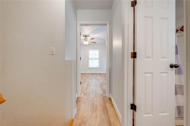 corridor with light hardwood / wood-style flooring