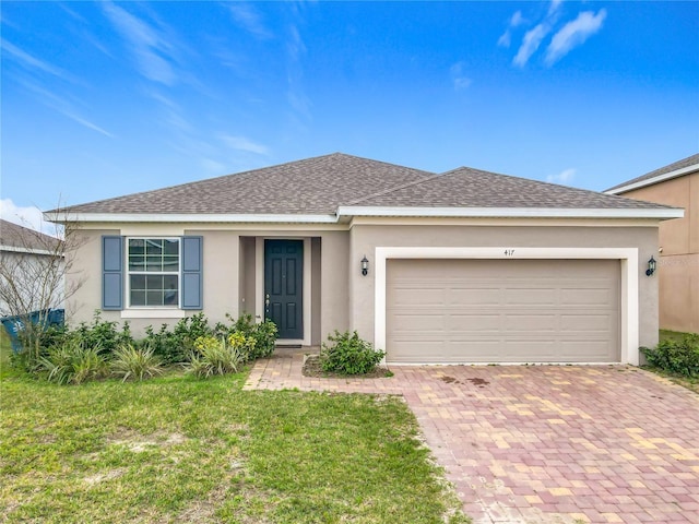 single story home with a garage and a front yard