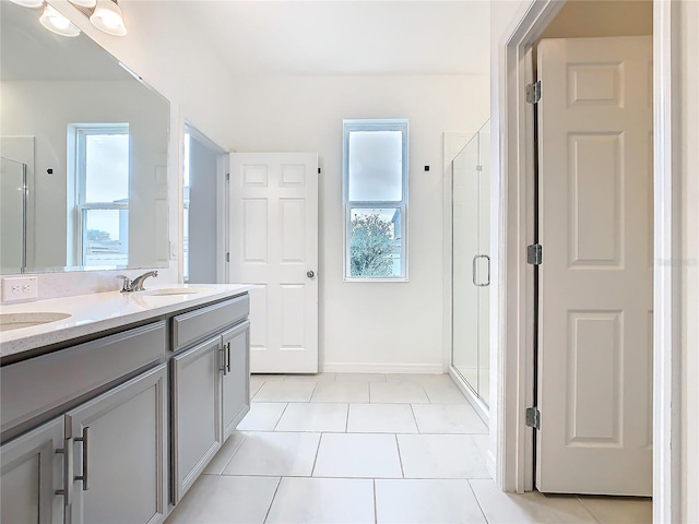 bathroom with vanity, tile patterned flooring, plenty of natural light, and walk in shower