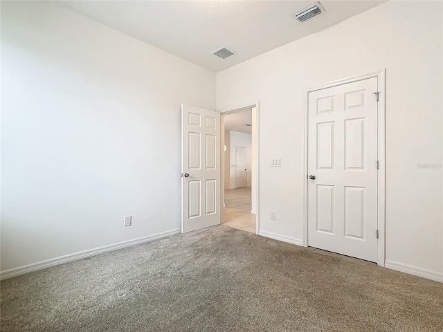 unfurnished bedroom with light carpet